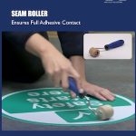 Seam Roller Removing Air Bubbles Under Warehouse Signage.jpg